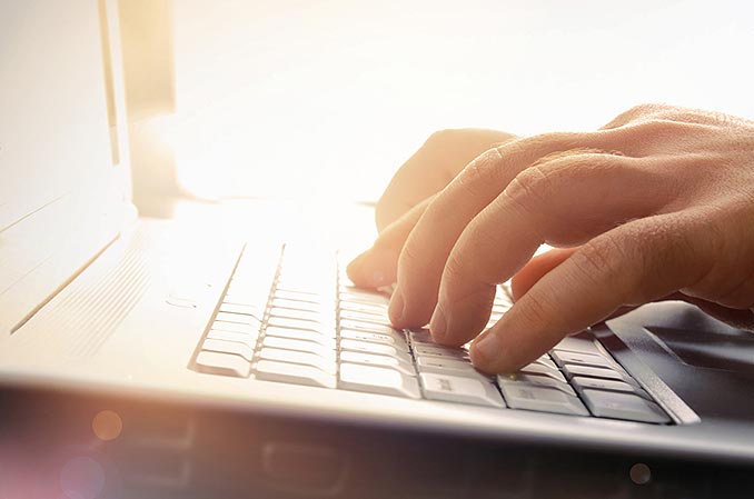 closeup of hands on laptop keyboard